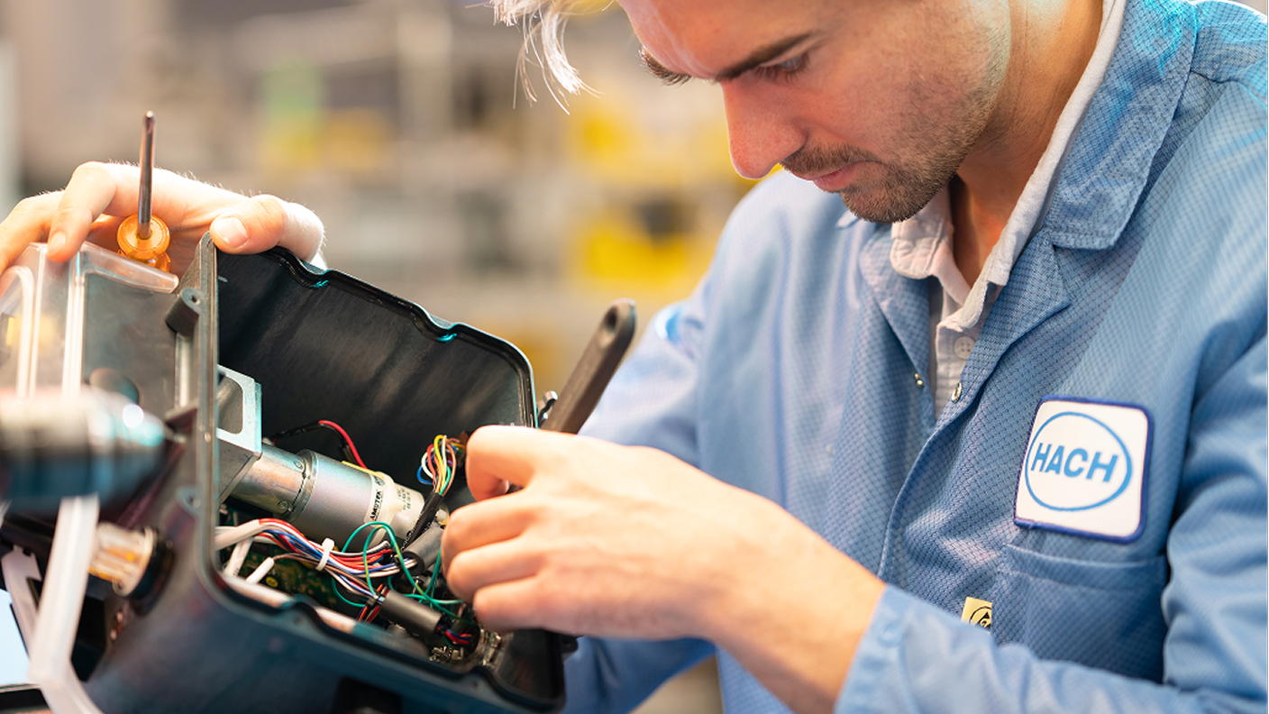 Hach technician repairing a water quality instrument